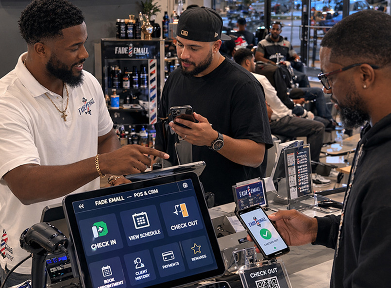 Front desk with a Fade 'Em All POS and CRM tablet as a client pays by phone